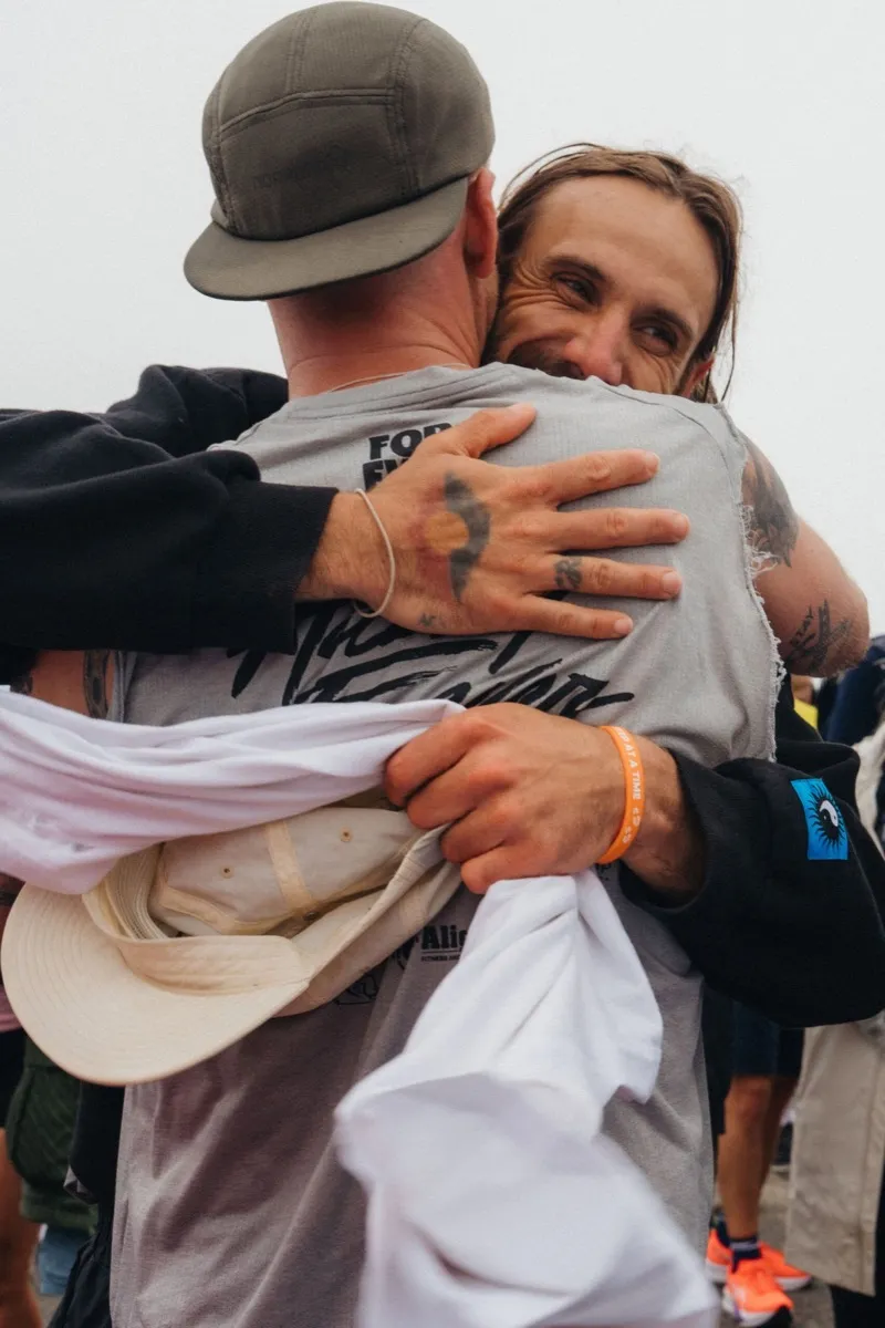 Two participants embracing after the finish