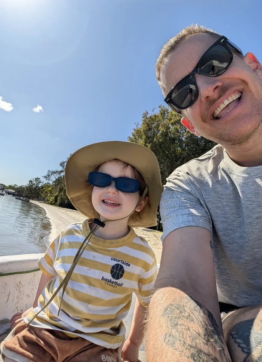 Hazzy and his dad on a boat